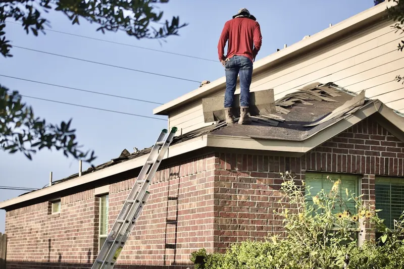Professional roofer working on a residential roof in The Arbors